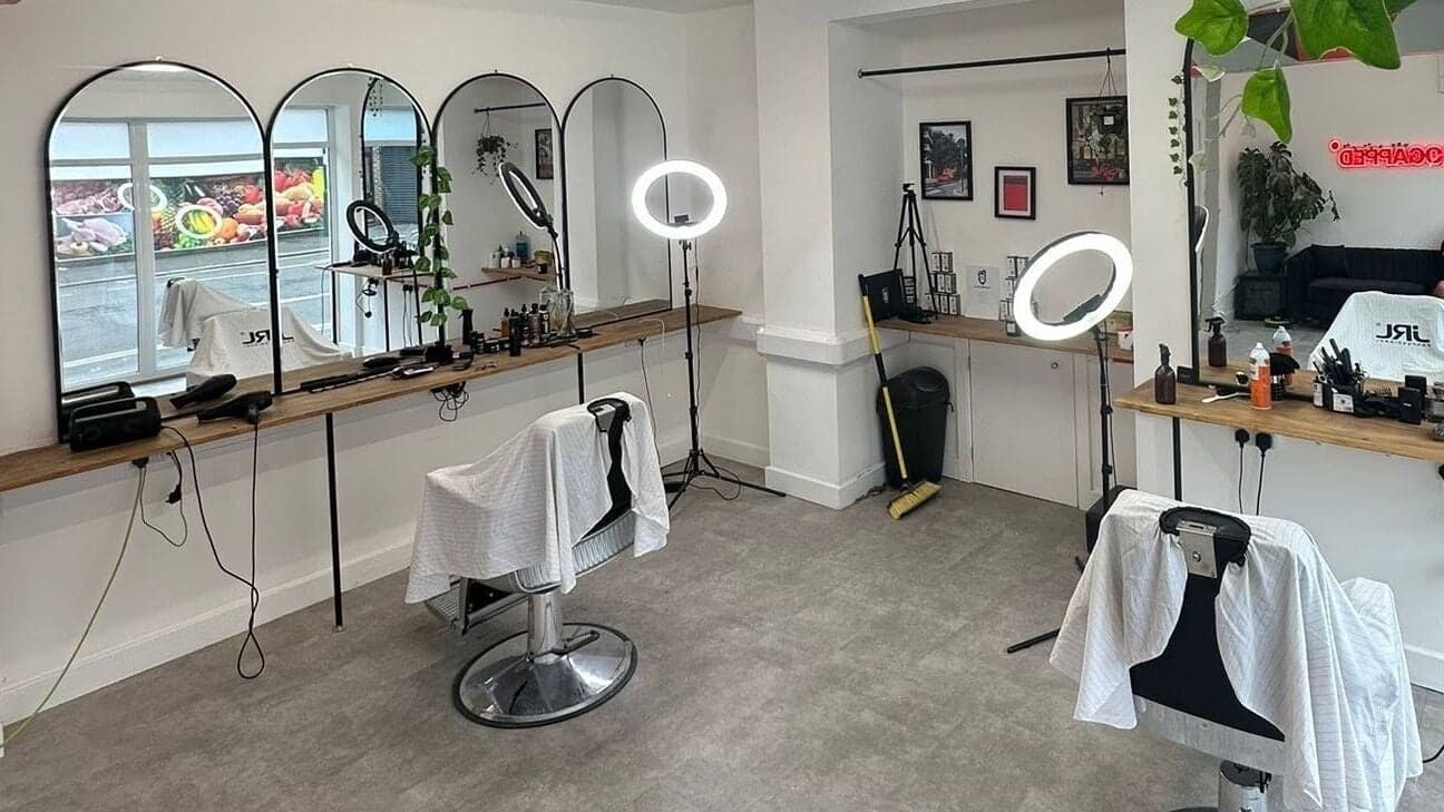 Arched mirrors and barber chairs inside HeroGapped Barber Studio