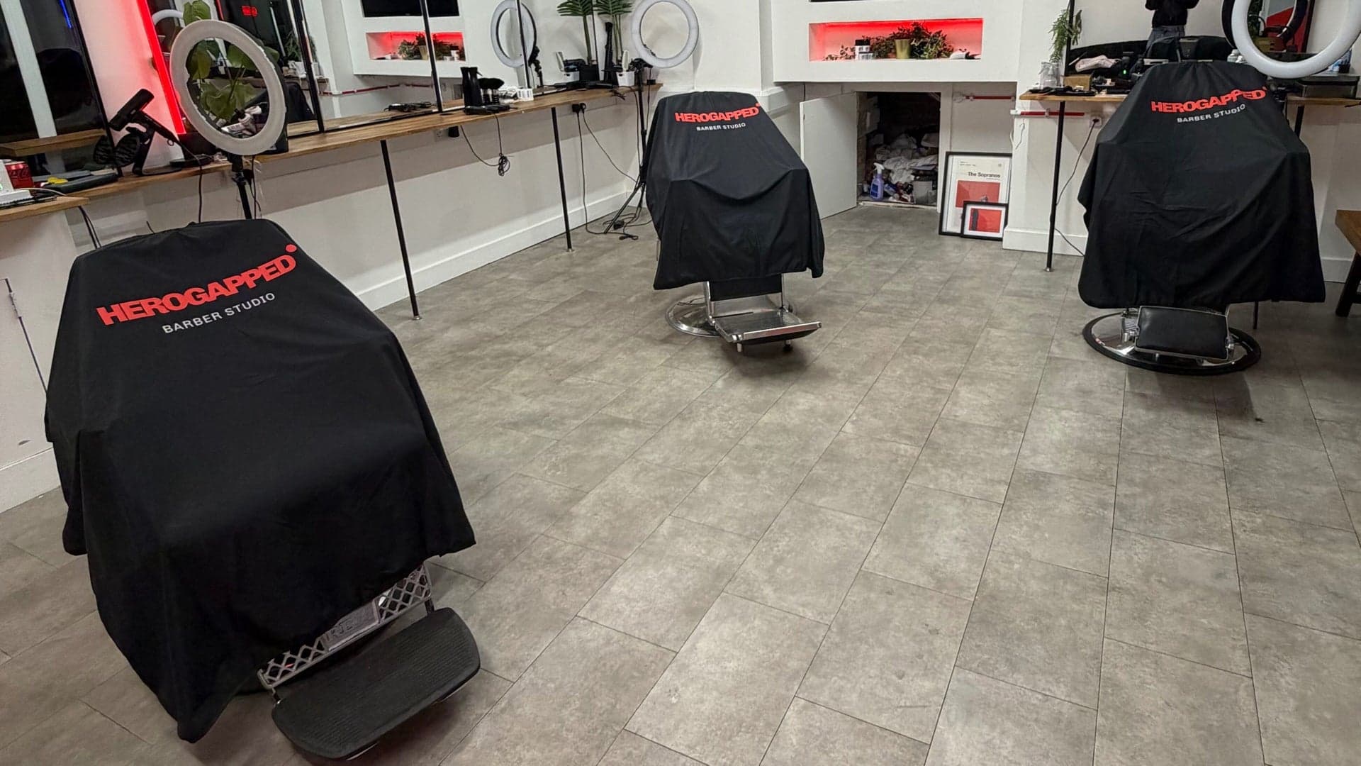 HeroGapped branded capes on the studio's barber chairs