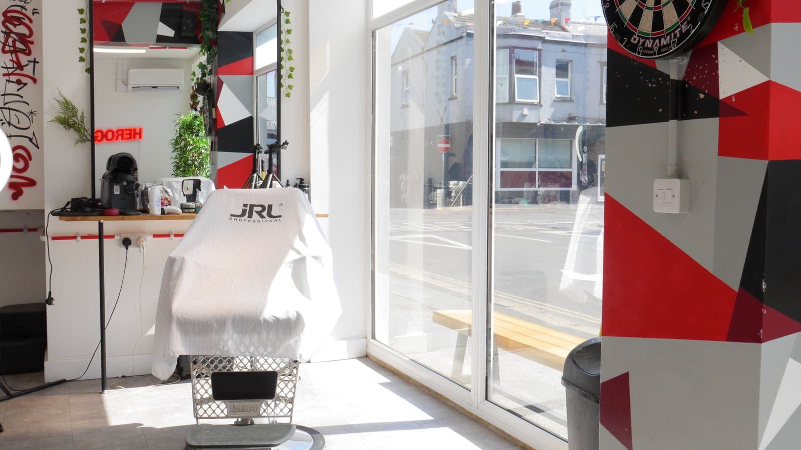 Barber chair by the window with the dartboard column and London Road outside